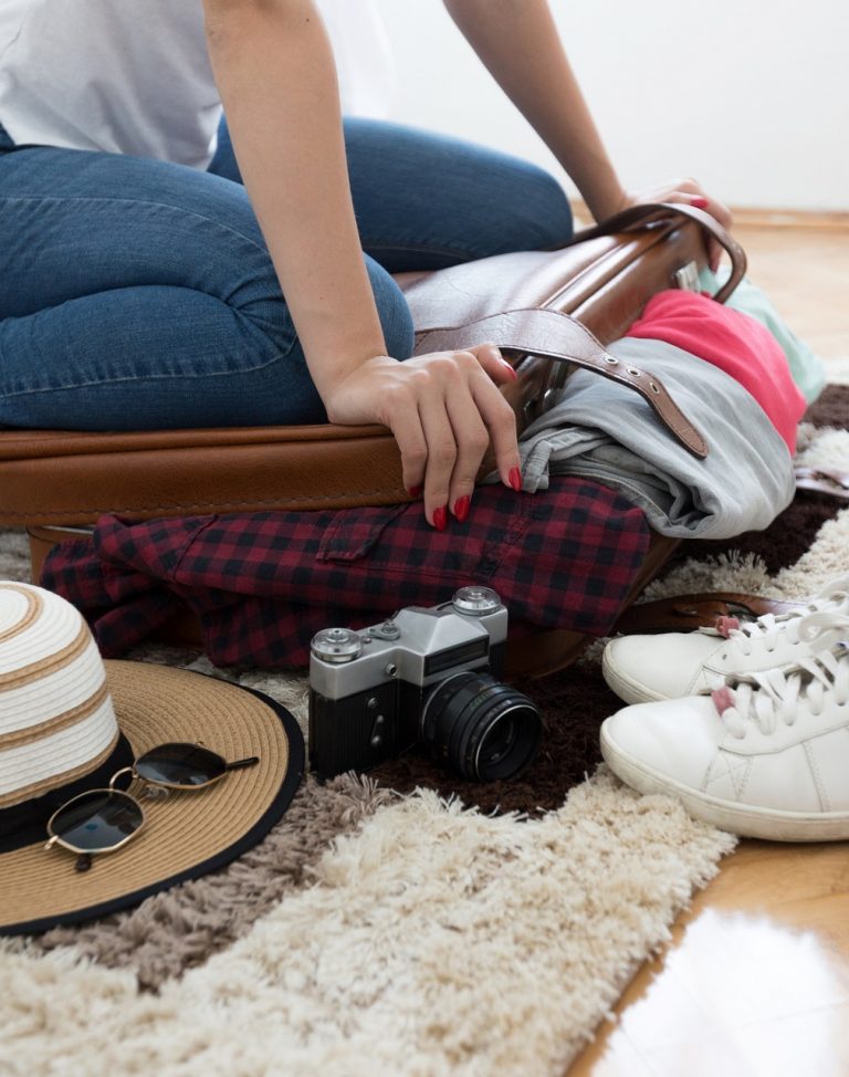 Woman sitting on overweight and baggage